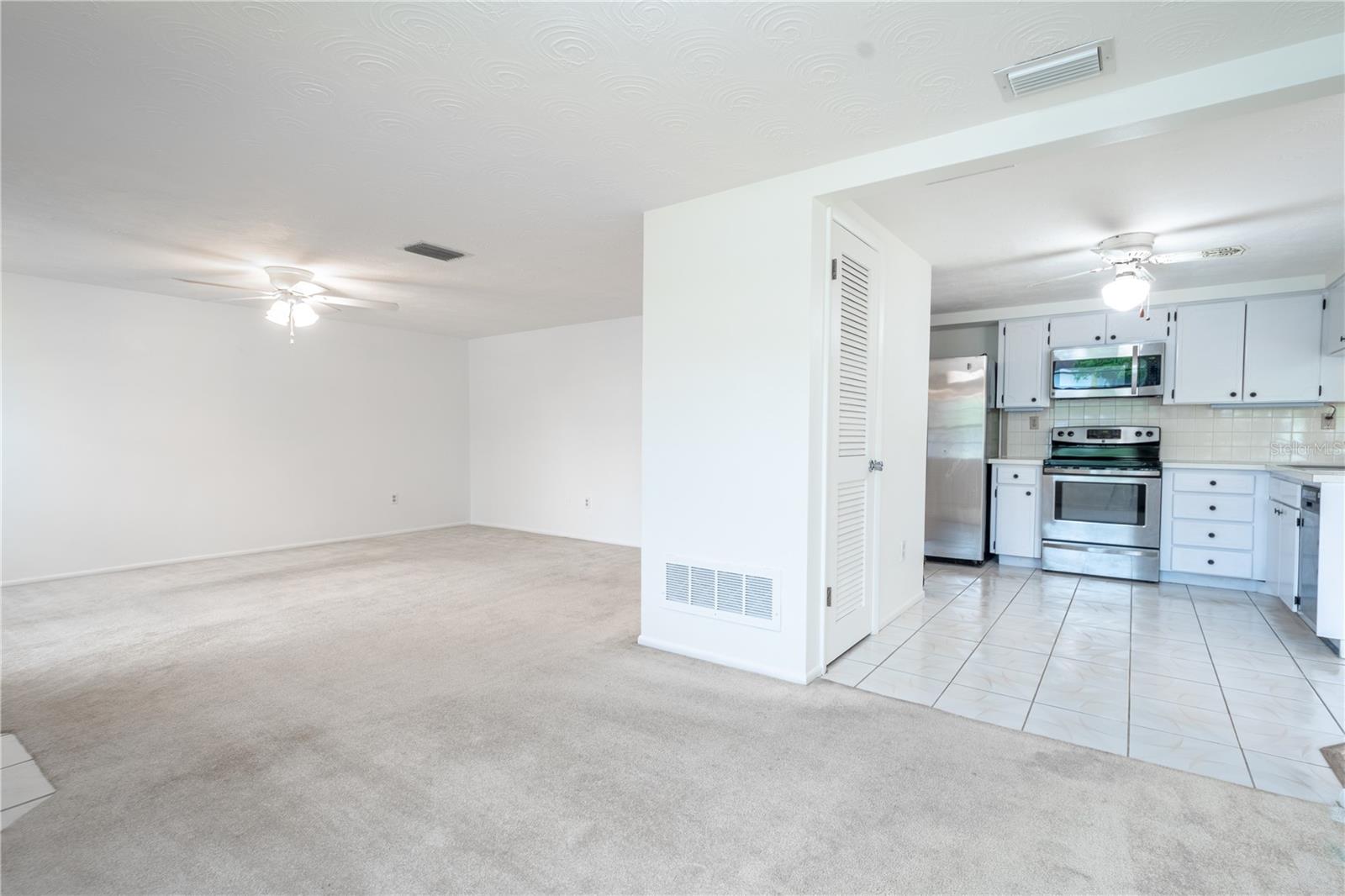 The living room features a ceiling fan with light kit.