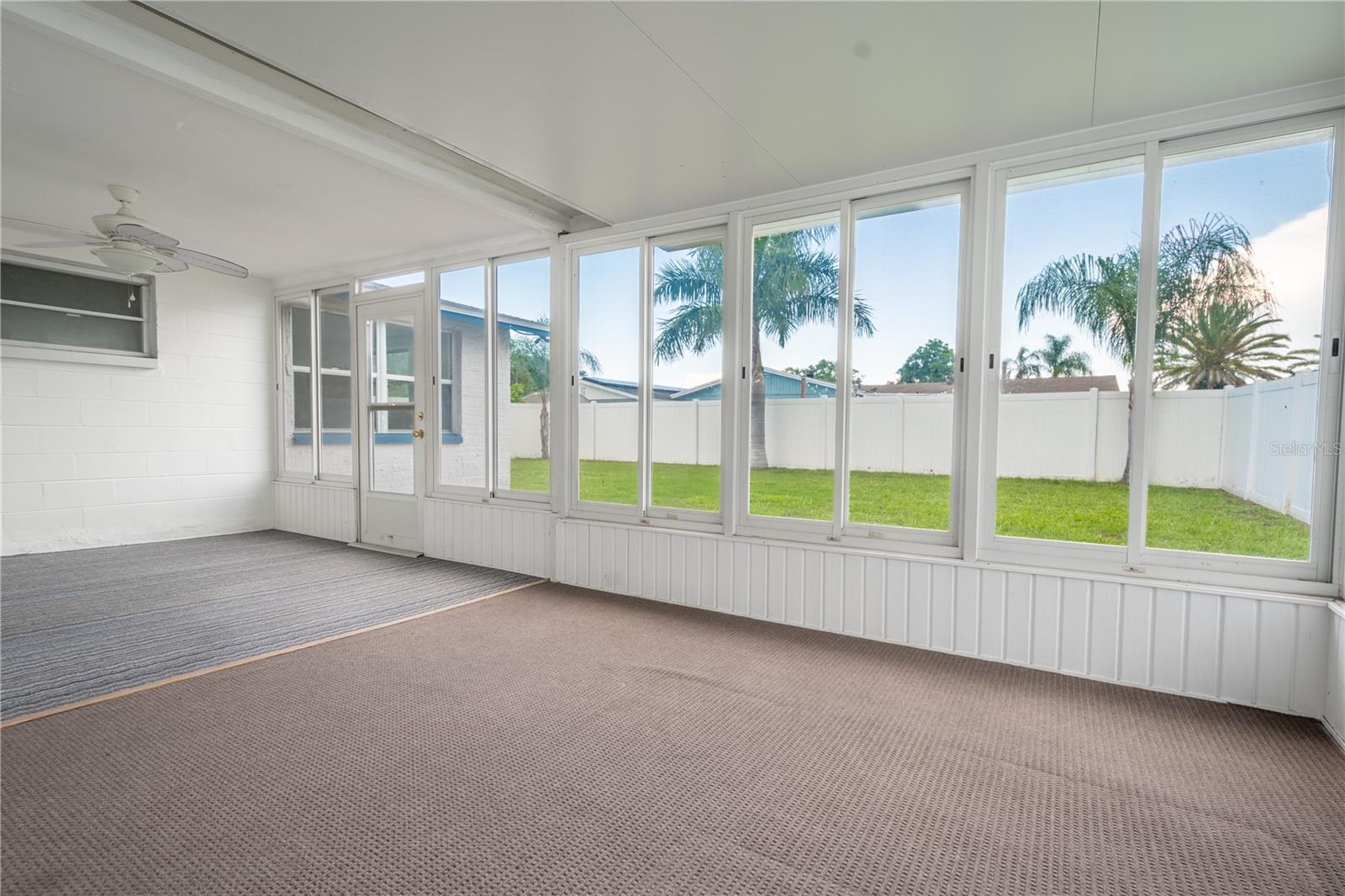 A great view of the private, fenced in backyard from the Florida Room