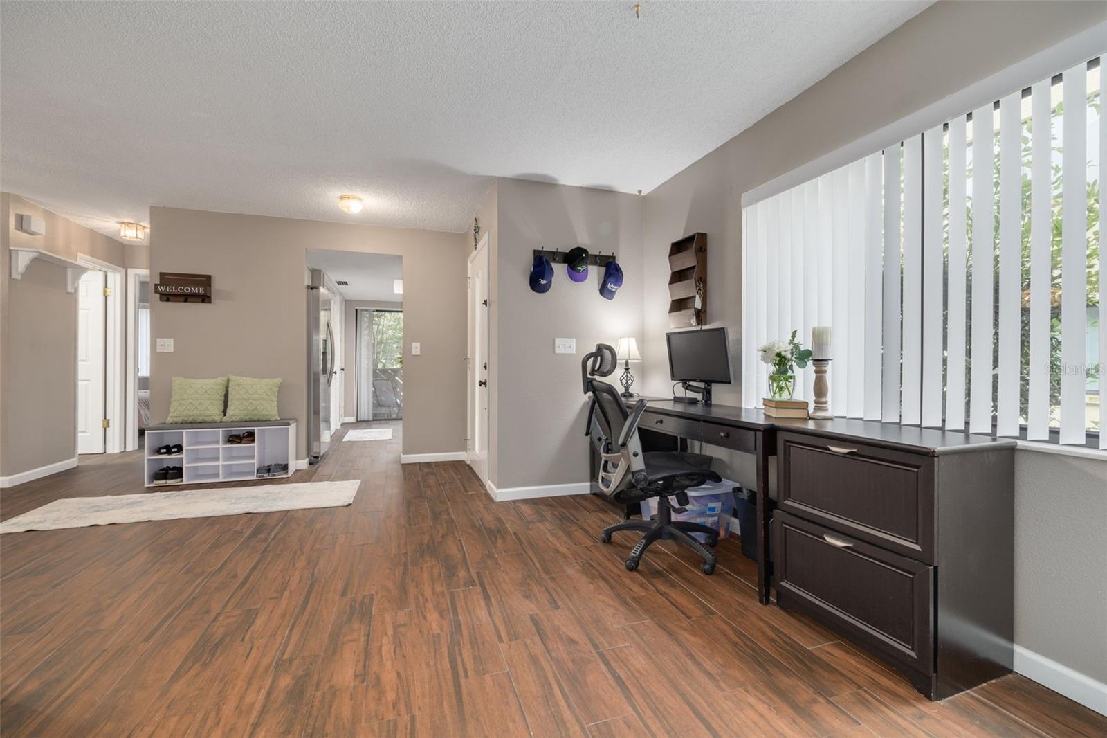 View of entry, walkway to kitchen, hallway to guest bedroom and bathroom