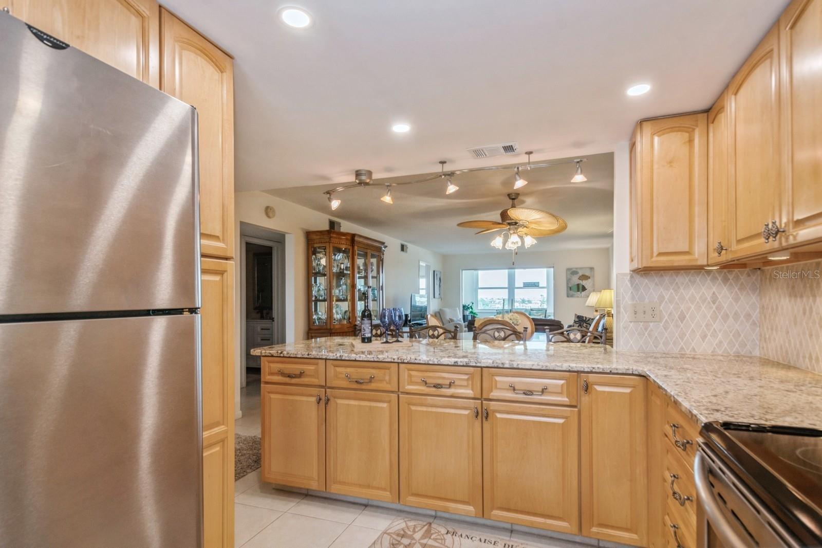 Open kitchen with granite counters and breakfast bar