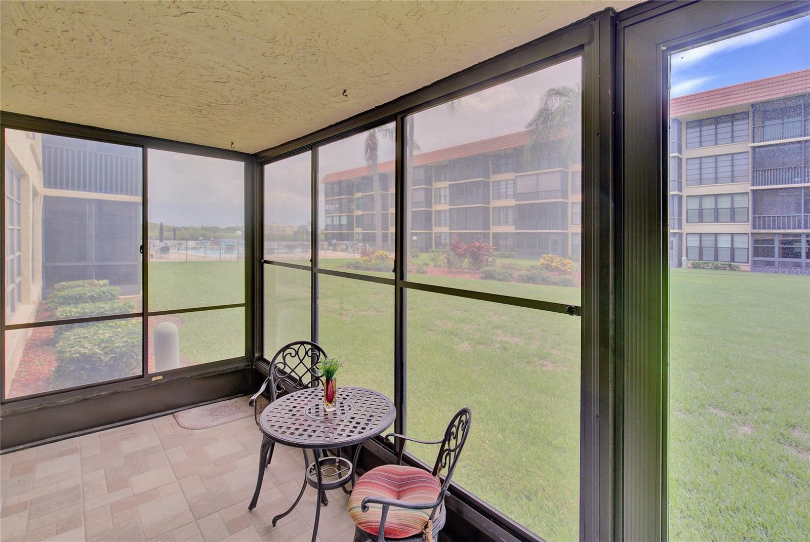 The enclosed porch has views of the pool and intracoastal waterway.