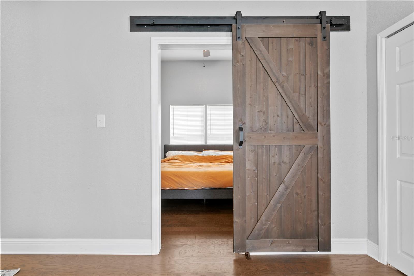 Barn door to master suite off the living room