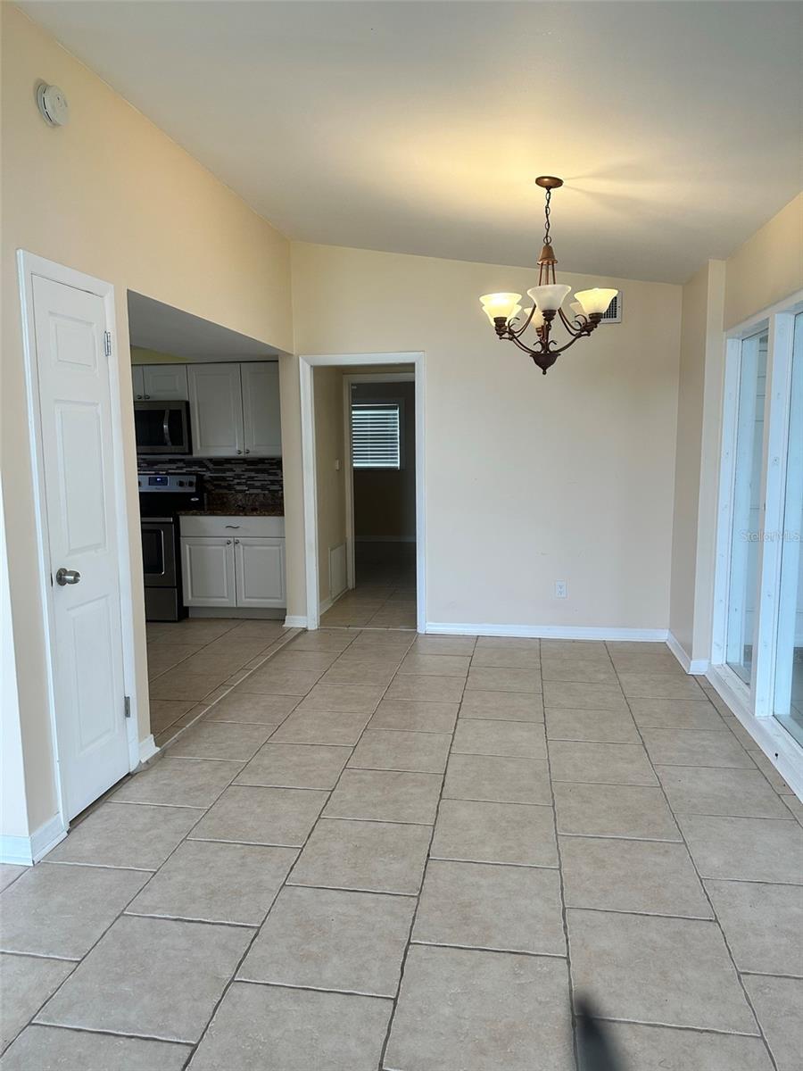 Dining room area; kitchen to the left and hallway with bedrooms ahead