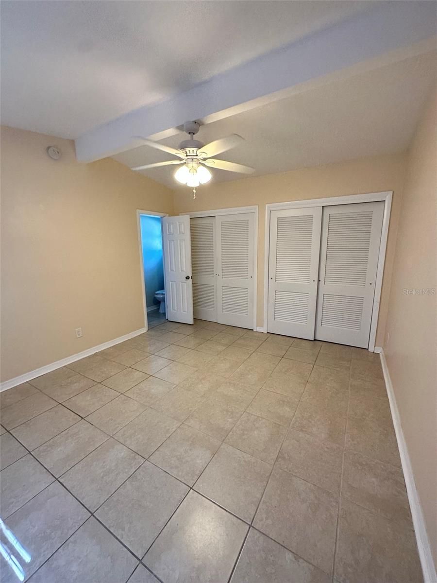 Master bedroom facing his and hers closet