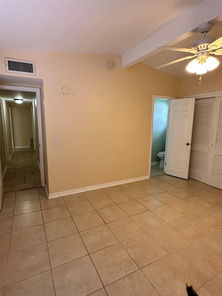 Master bedroom facing bathroom door and hallway