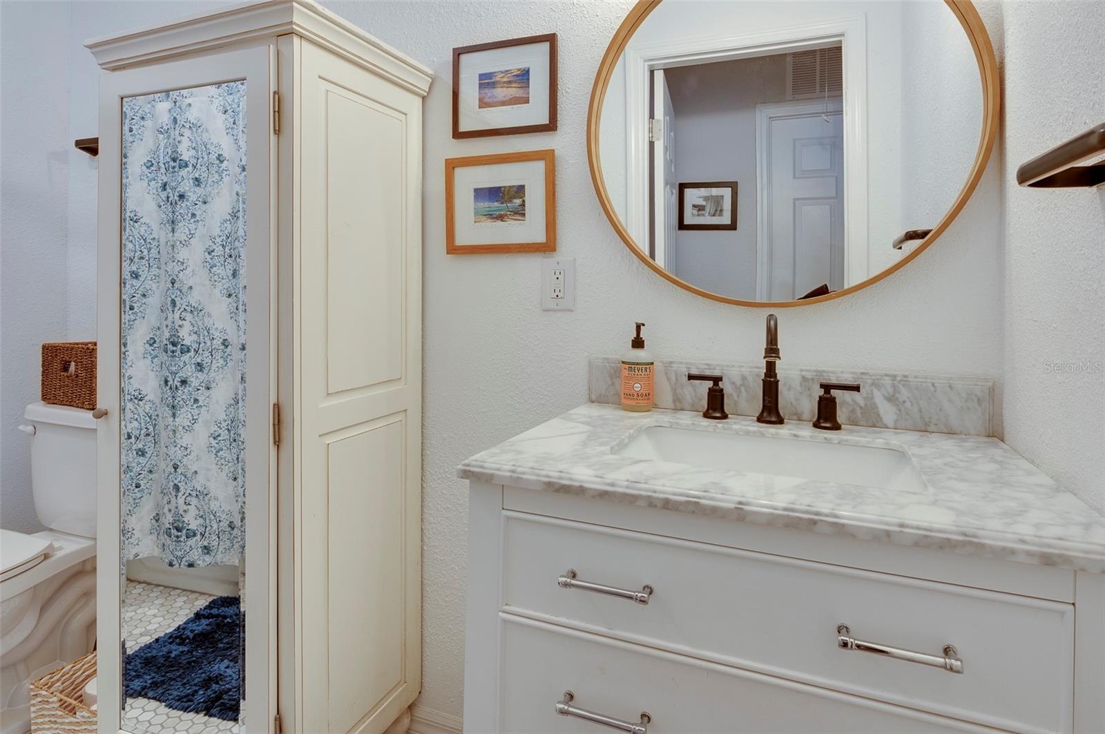 Second Bathroom, Vanity, Armoire with mirror reflecting bathtub with shower