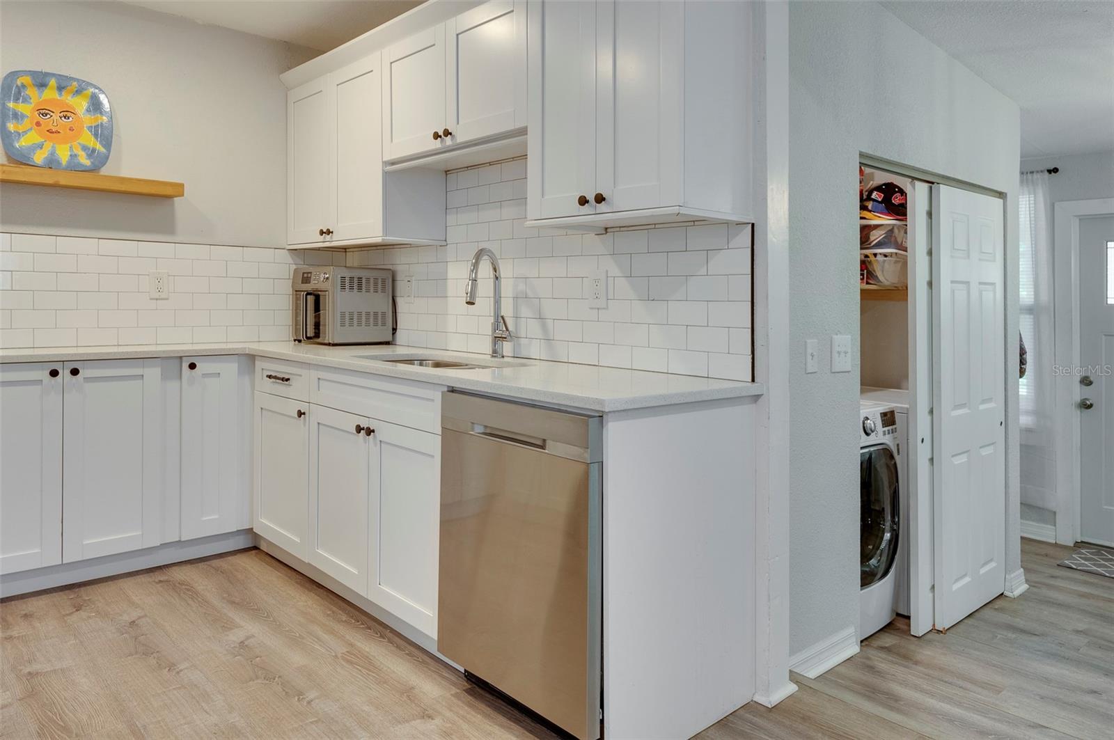 Kitchen viewing down to DR and Laundry Closet