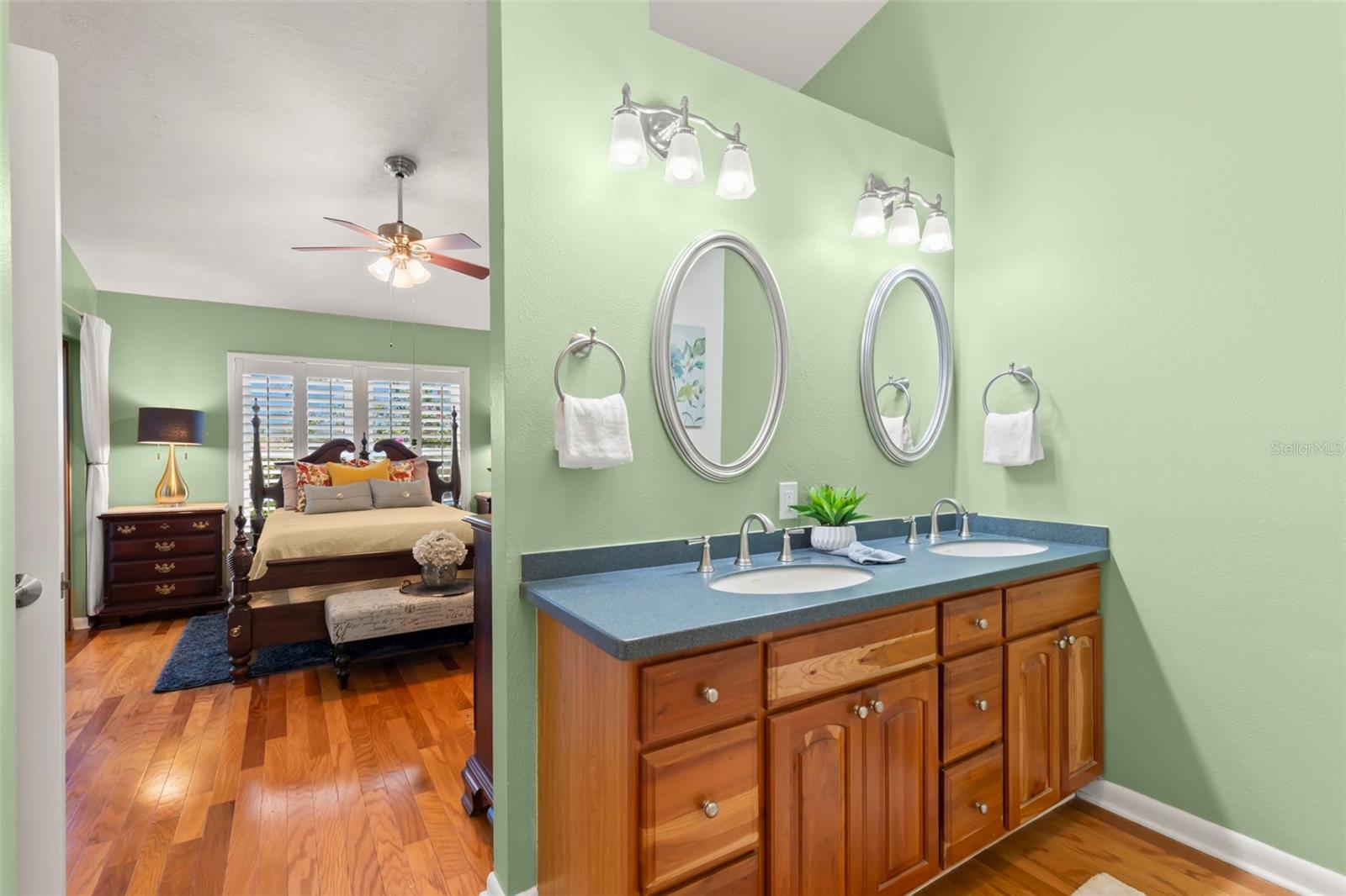 Dressing area with double sinks and coastal Corian counters.