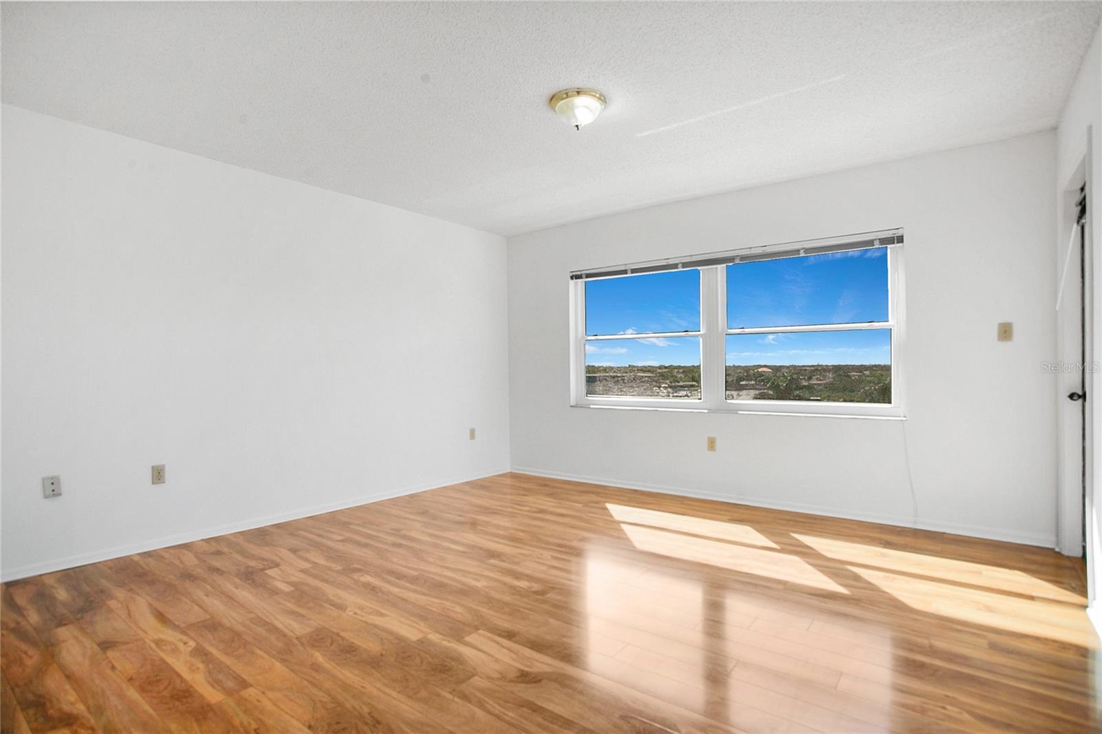 Primary bedroom can easily accommodate a king sized bed and large furnishings