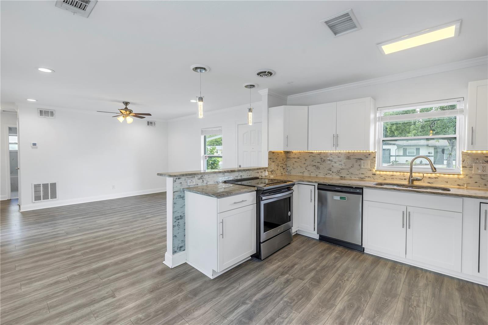 Updated kitchen with stainless appliances and granite counters