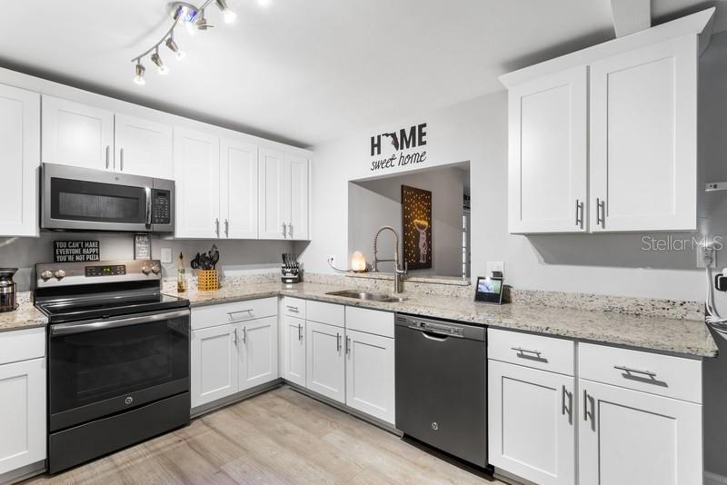 THERE IS PLENTY OF COUNTER SPACE IN THIS BEAUTIFULLY DESIGNED KITCHEN.