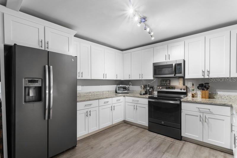 CROWN MOLDING TRIMS THE TOP OF CABINETS.  YOUR FRIENDS AND FAMILY CAN HELP PREPARE MEALS IN THIS LARGE KITCHEN!