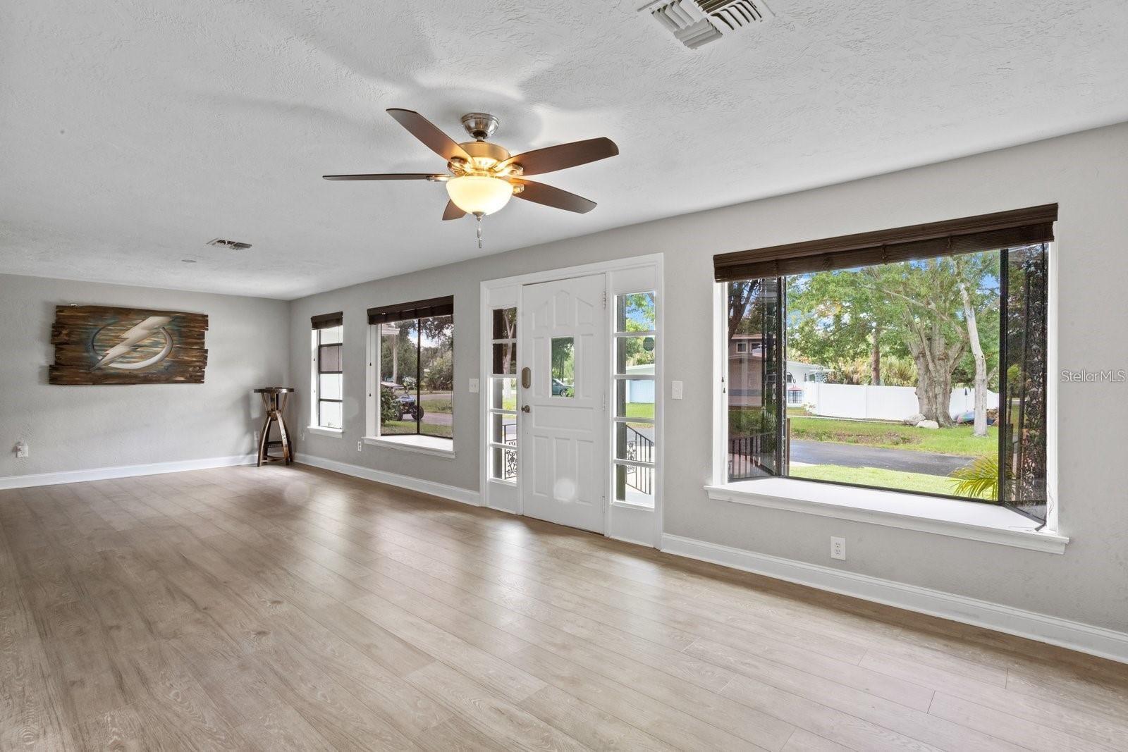 BLANK CANVAS OF OPEN CONCEPT LIVING & DINING AREAS.