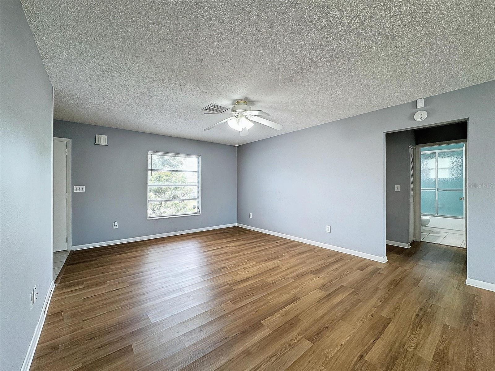 Living Room looking into hallway with guest bathroom and secondary bedrooms