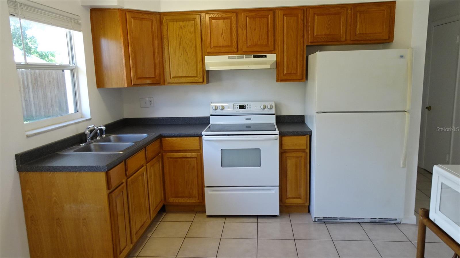 Kitchen sink/window overlooks the rear yard with lots of play room.