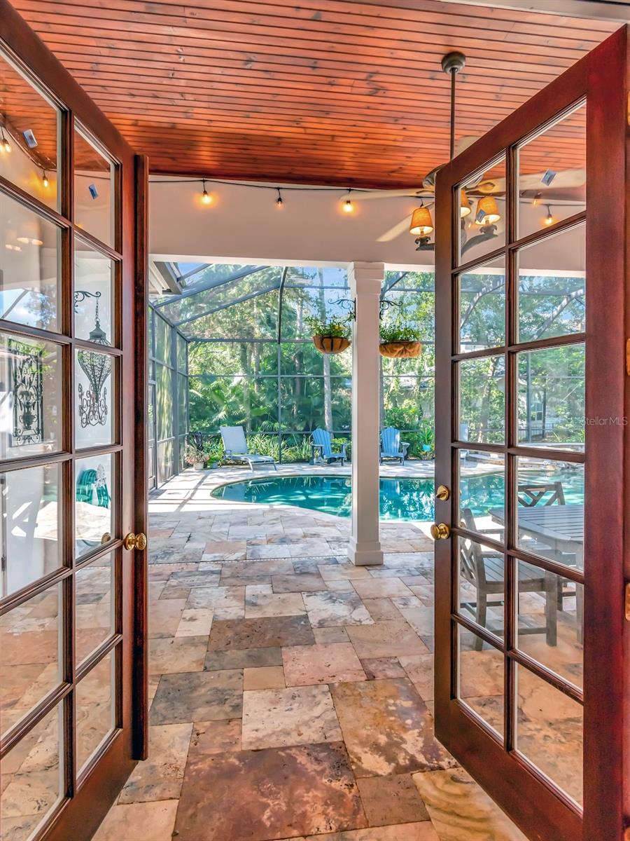 Wood Ceilinged Dining Area with Outdoor Chandeliers