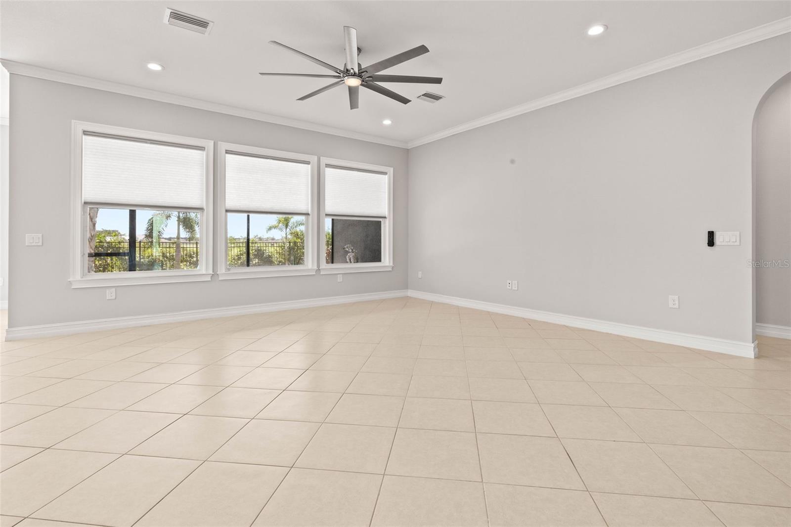 Living Room with 3 large windows overlooking the pool