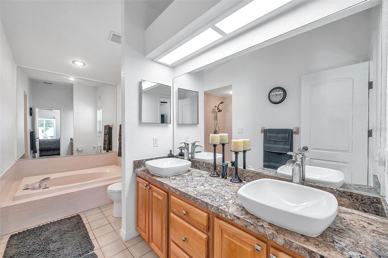 The primary bathroom has double sinks, a large garden tub, and a walk-in shower.