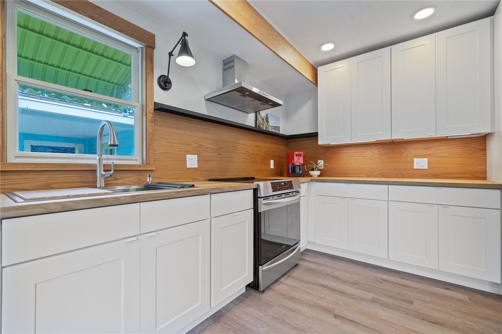 New White Oak backsplash and a brand new range hood & induction range