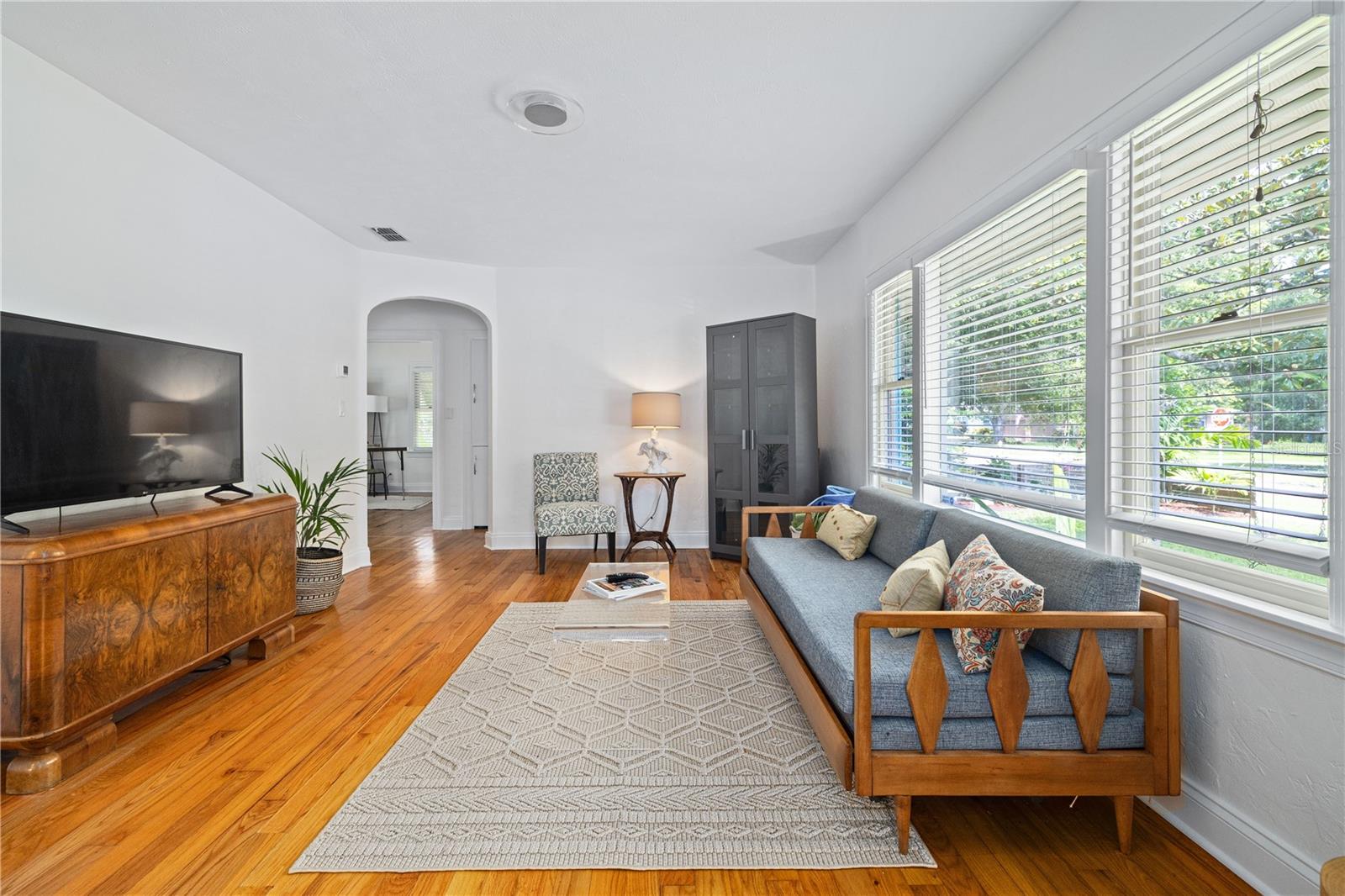 Formal Living Room with curved archway and textured ceiling & walls