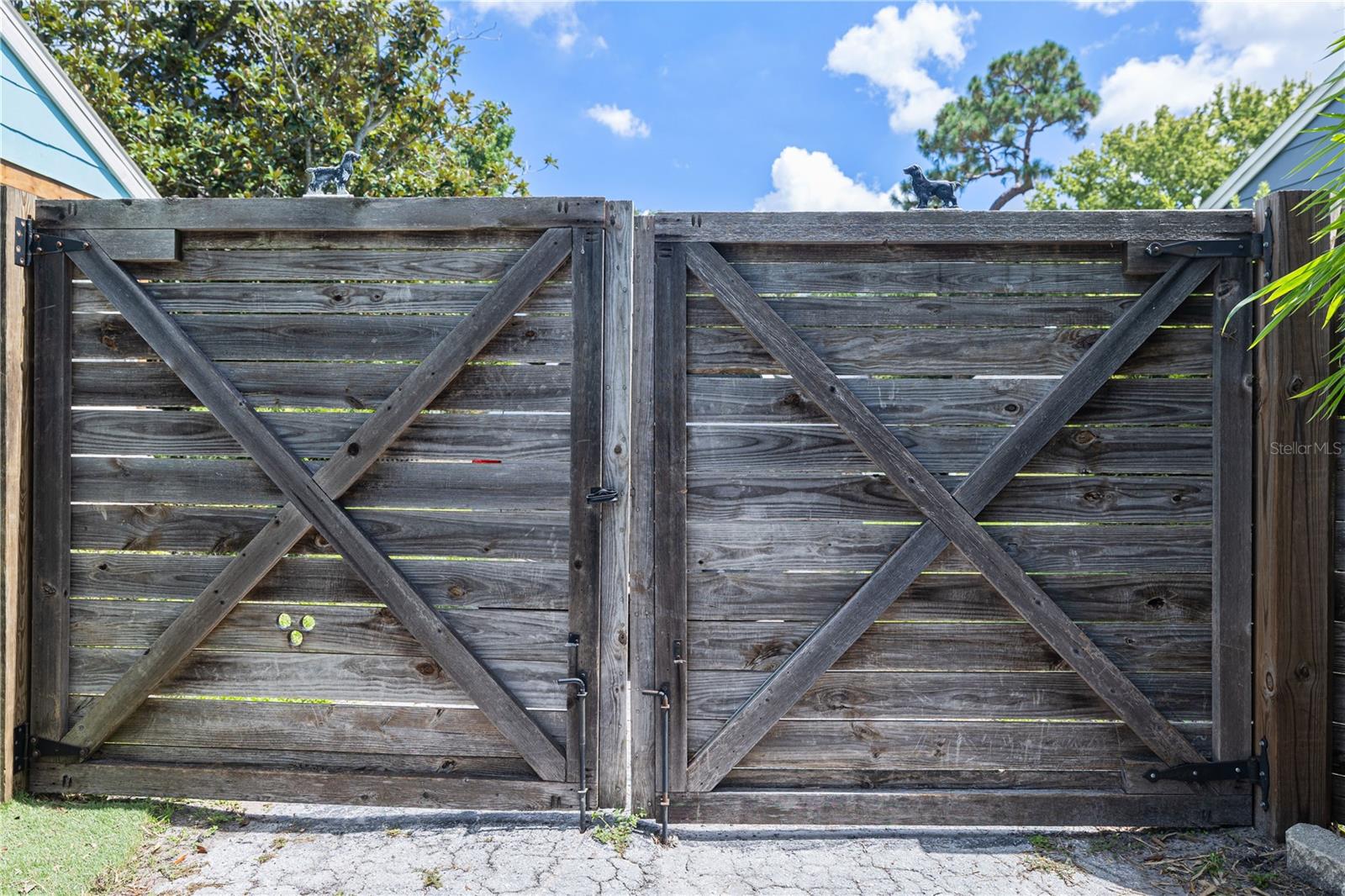 Other side of home with side by side swing gate allowing full access to back yard for additional vehicles, boat or RV