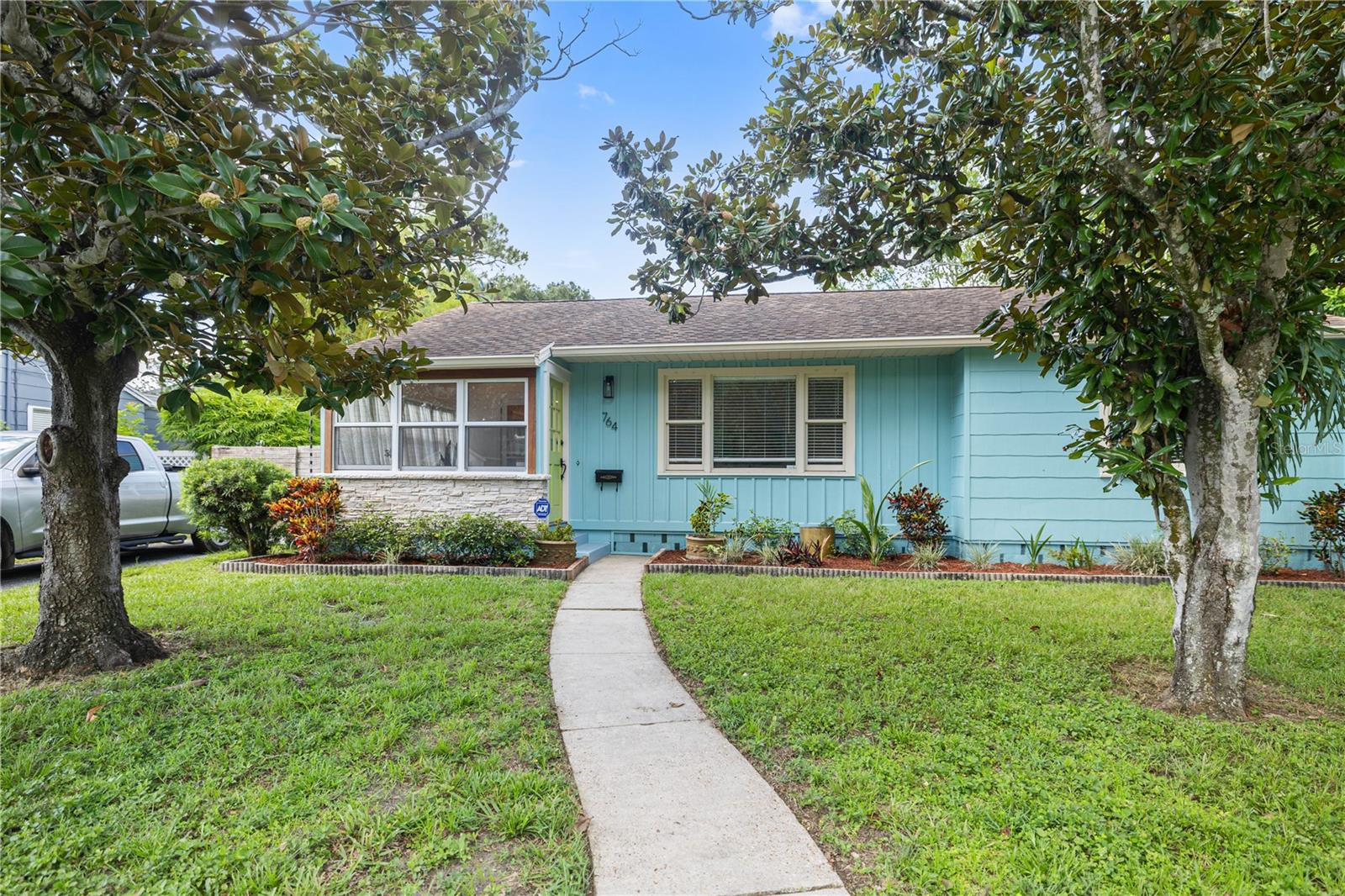 Exterior of home with sidewalk located on a brick street.