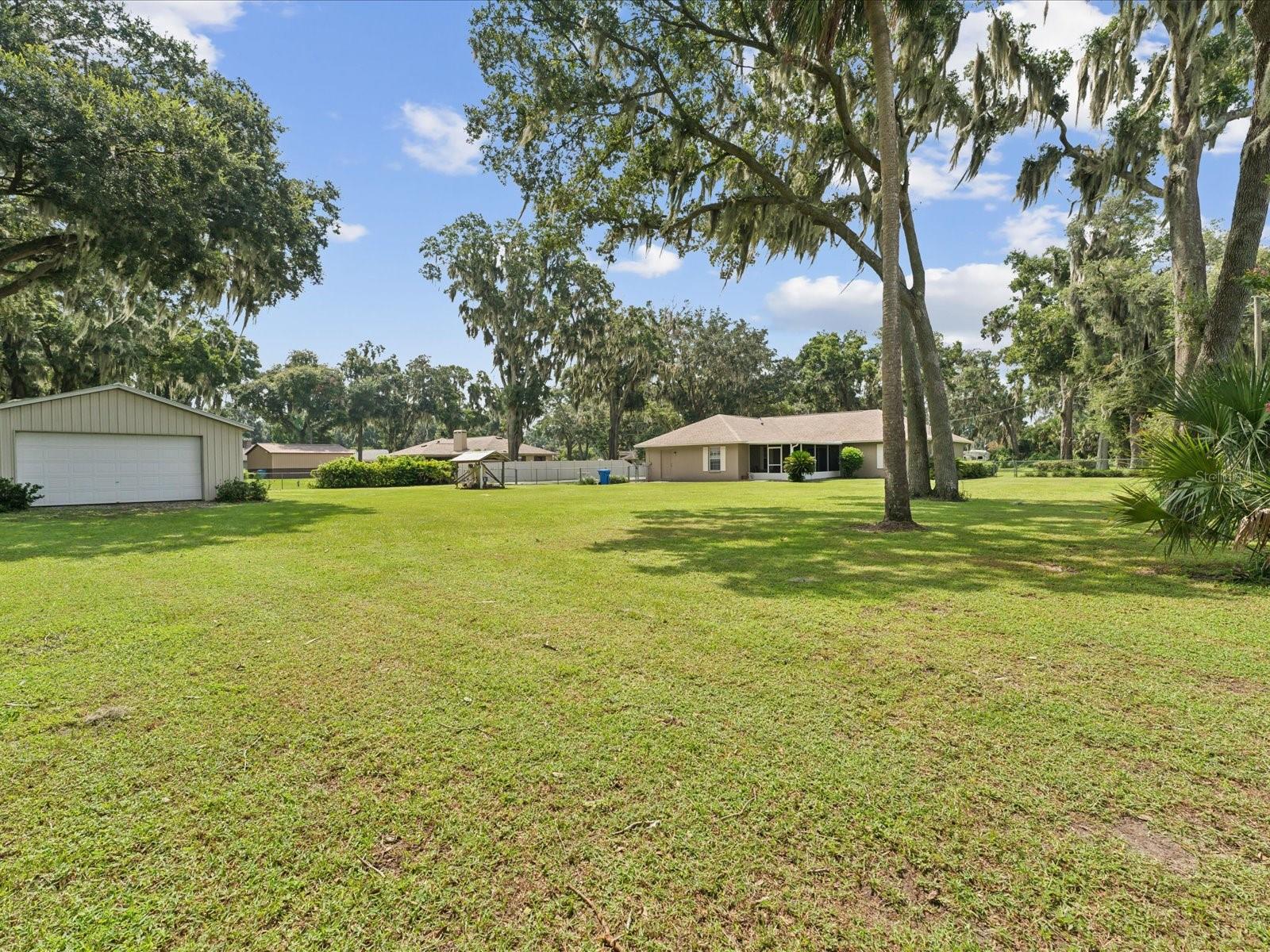 beautiful yard view from double gated fence and corner of property