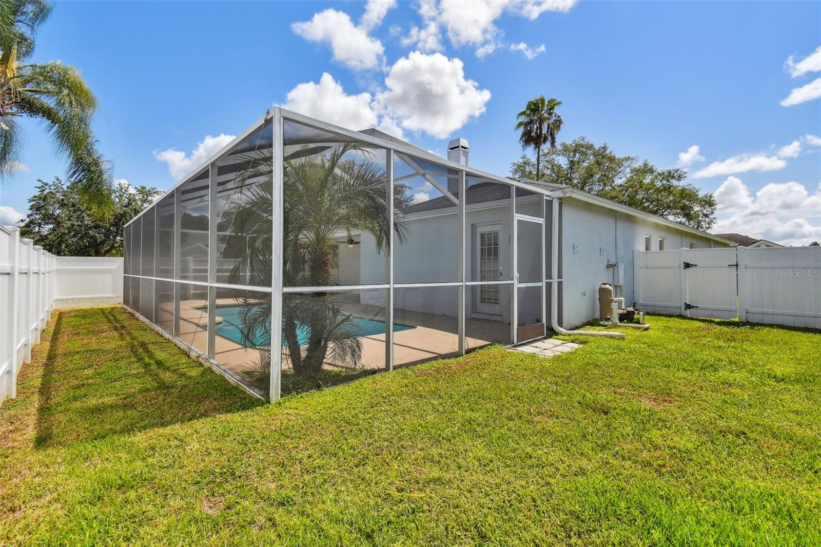 Fully fenced backyard w/grassy area