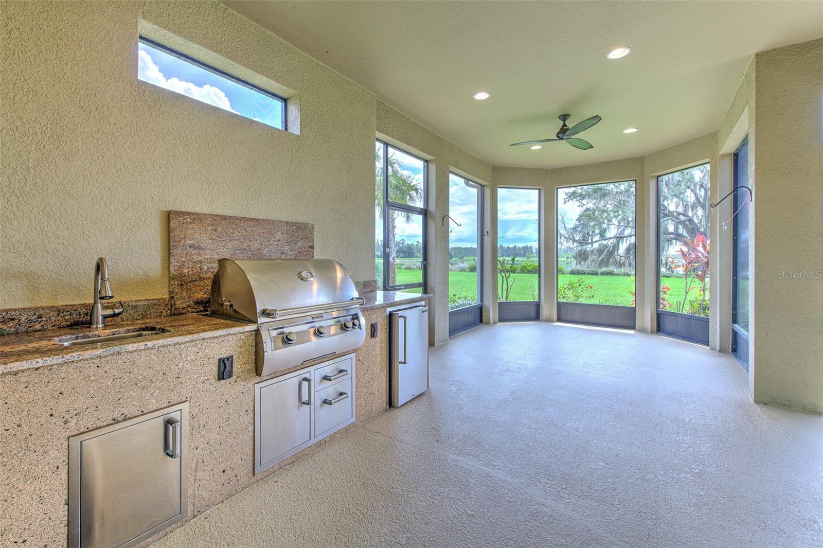 Outdoor kitchen on covered & screened in Lanai overlooking the water!