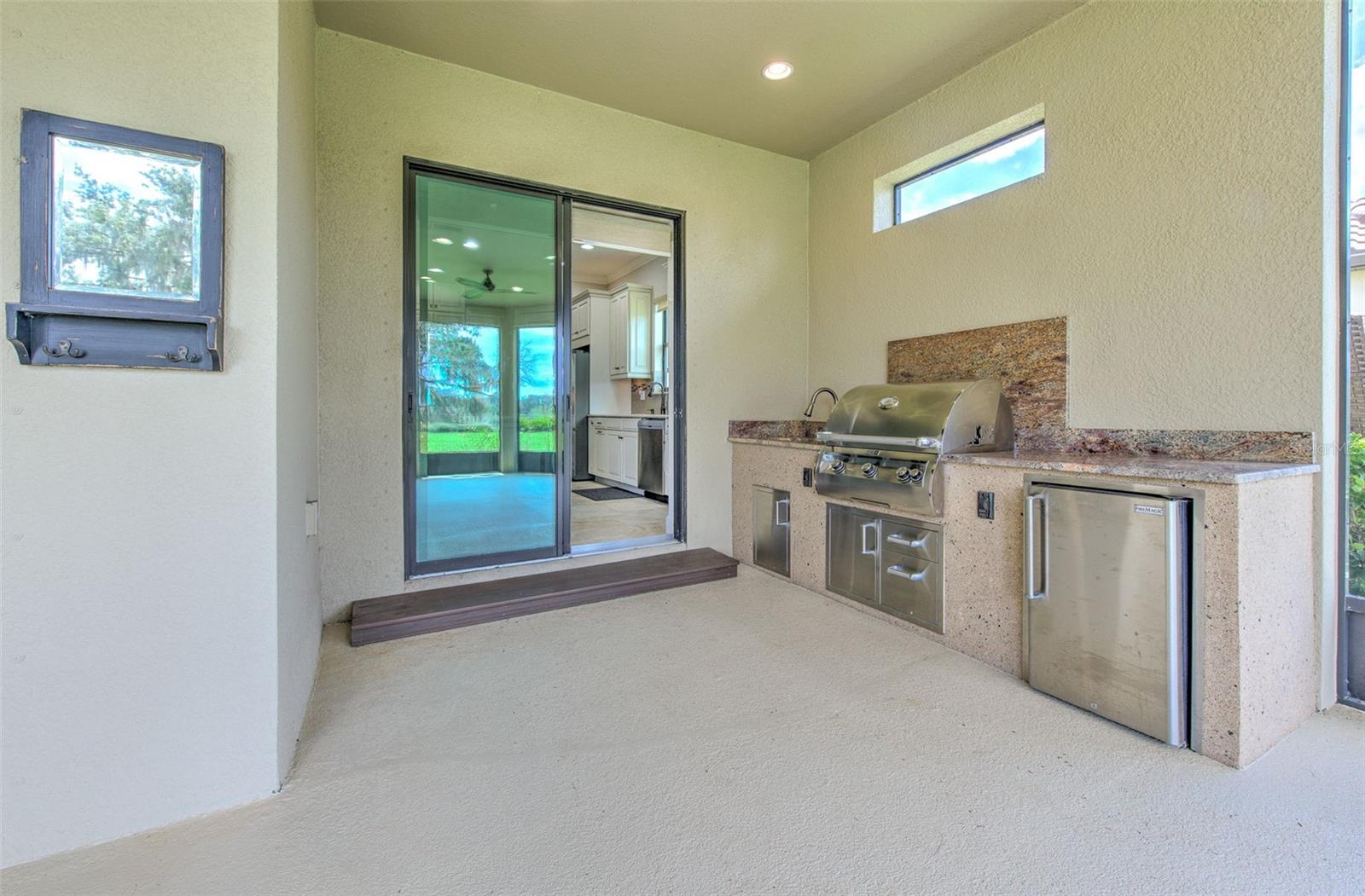 Outdoor kitchen on covered & screened in Lanai overlooking the water!