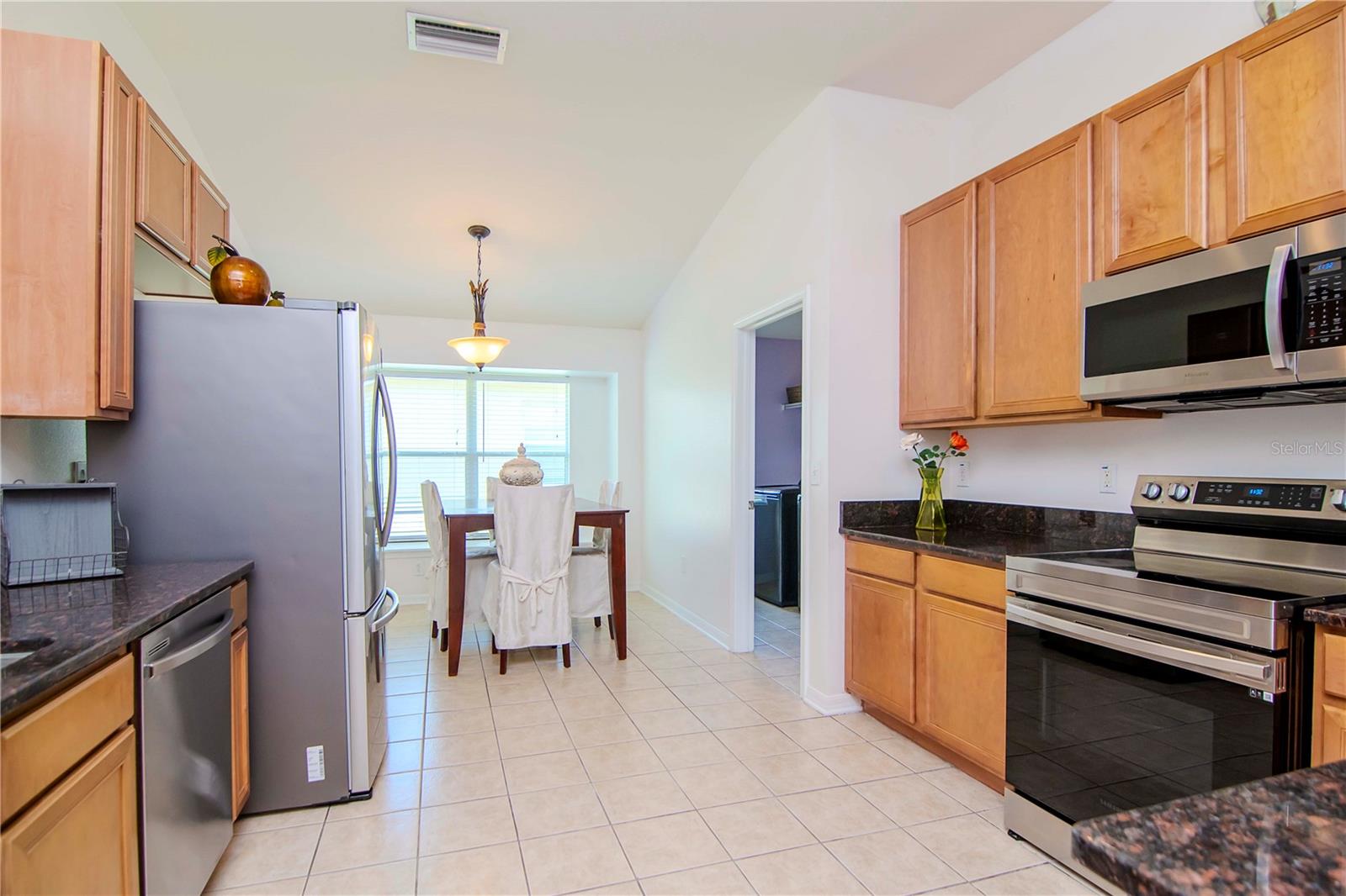 Kitchen includes stainless steel appliances and stone counter tops