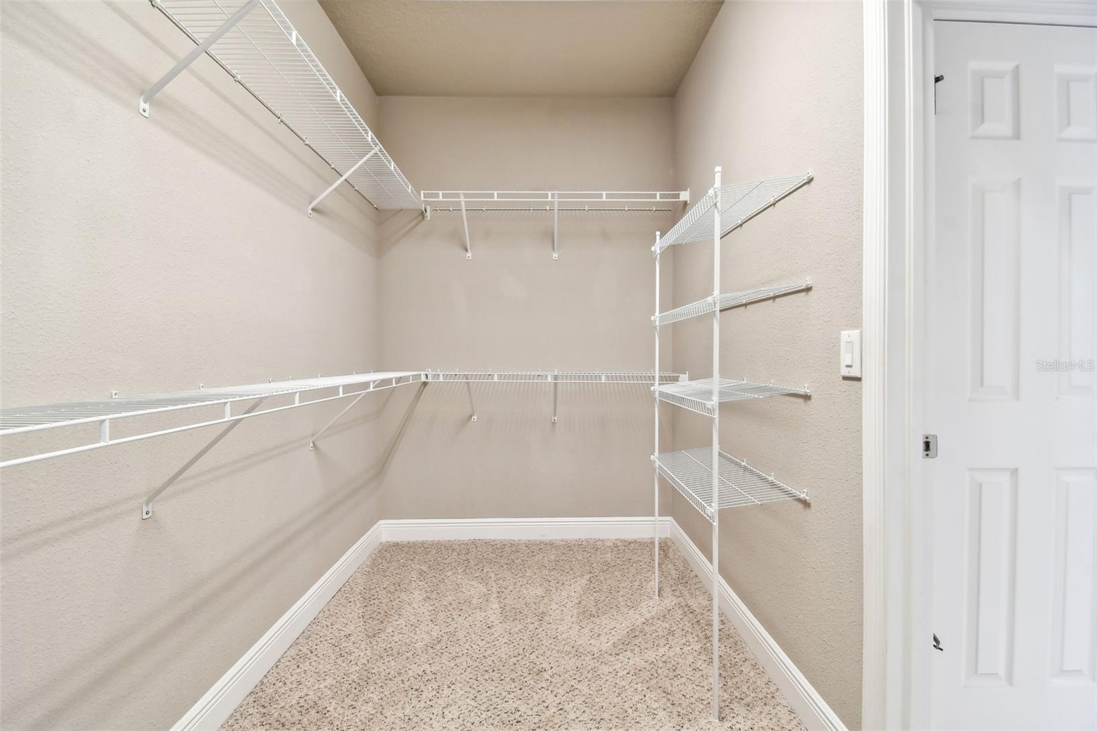 Primary bedroom walk-in closet