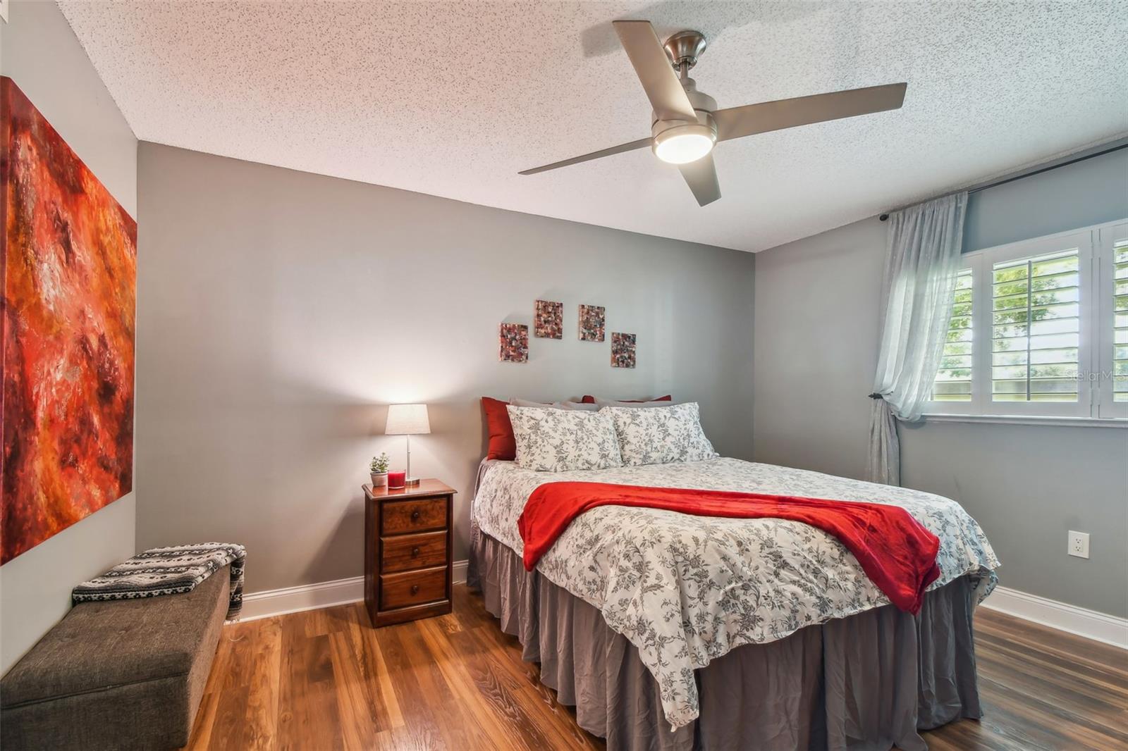 Gorgeous primary bedroom, with modern baseboards, fan/light and just-installed plantation shutters. Beautiful!