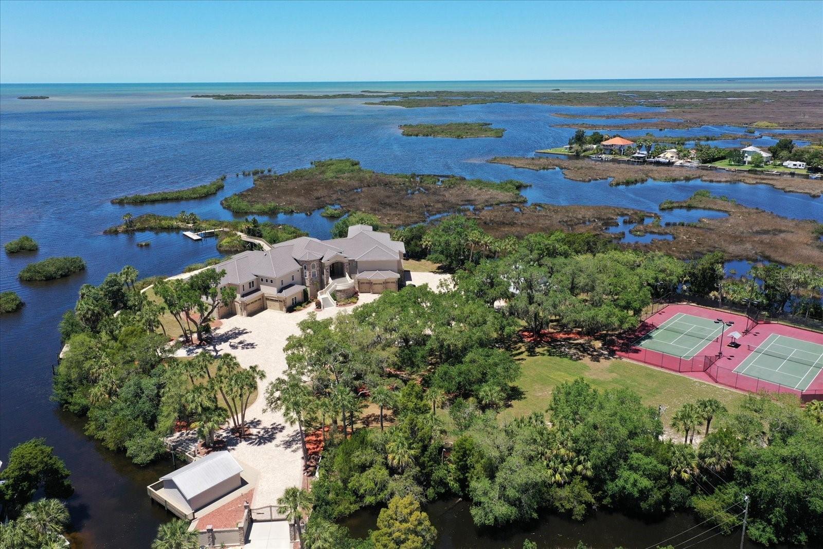 Aerial - two lighted tennis courts, boat house, and boat ramp