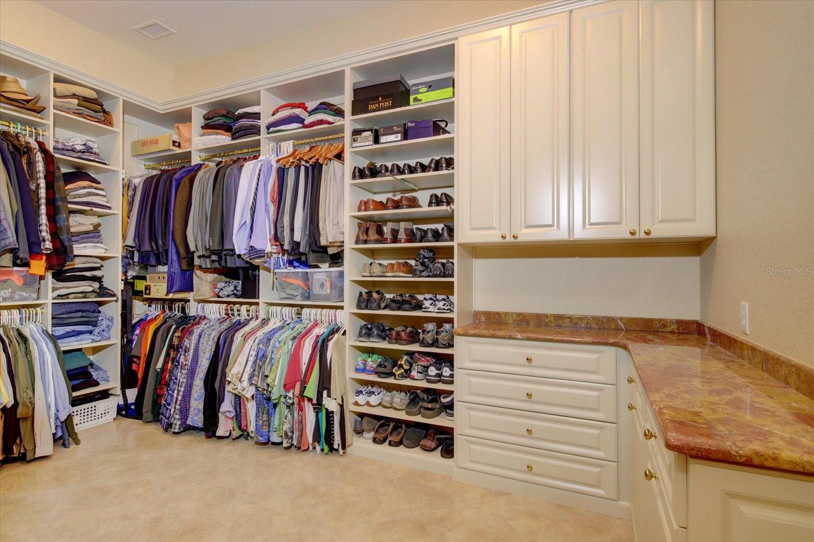 Massive walk-in custom closets, with built in cabinets, shoe racks and shelving