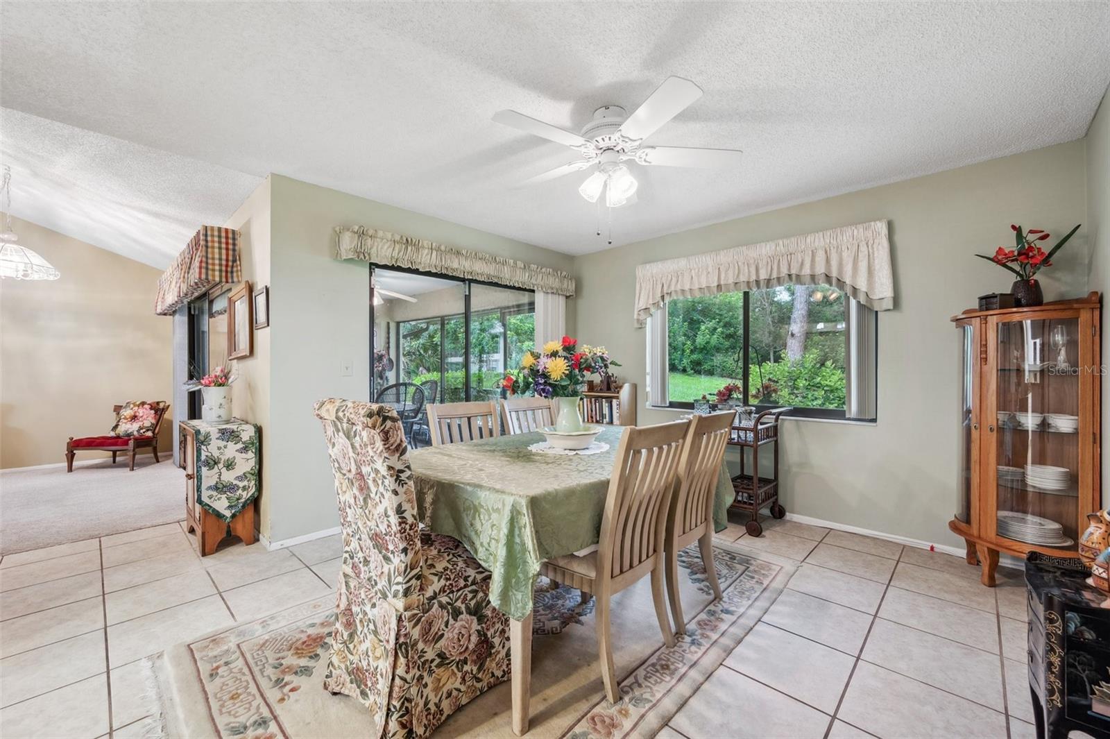 The dining room overlooks the beautiful backyard and the Florida room