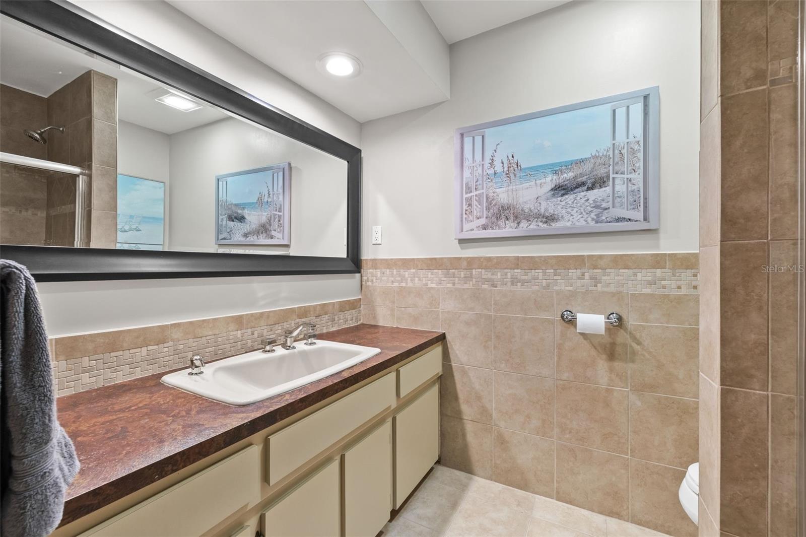 Full hallway bathroom with tub and shower.