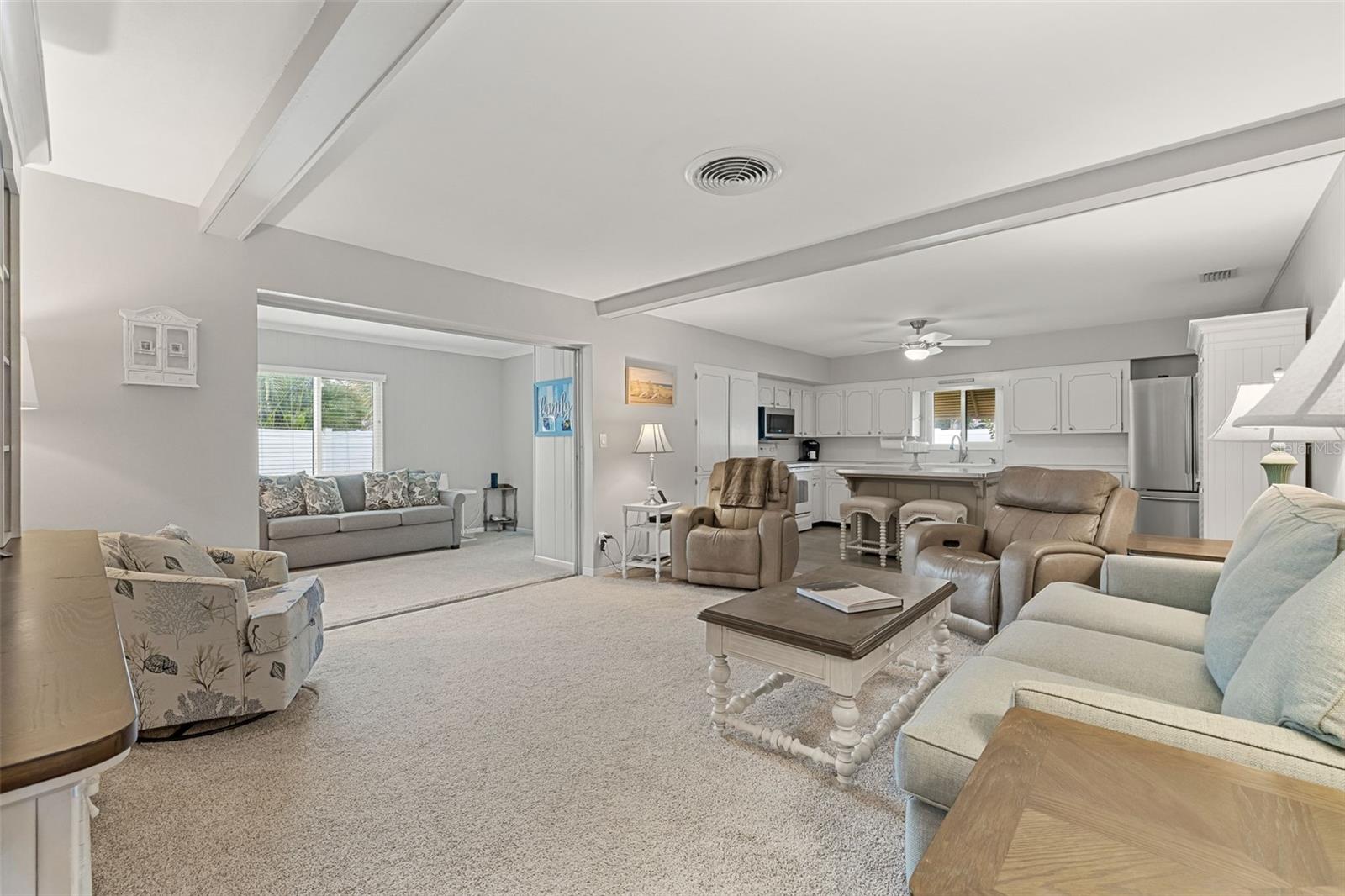 Open space shows kitchen, living room and bonus room.