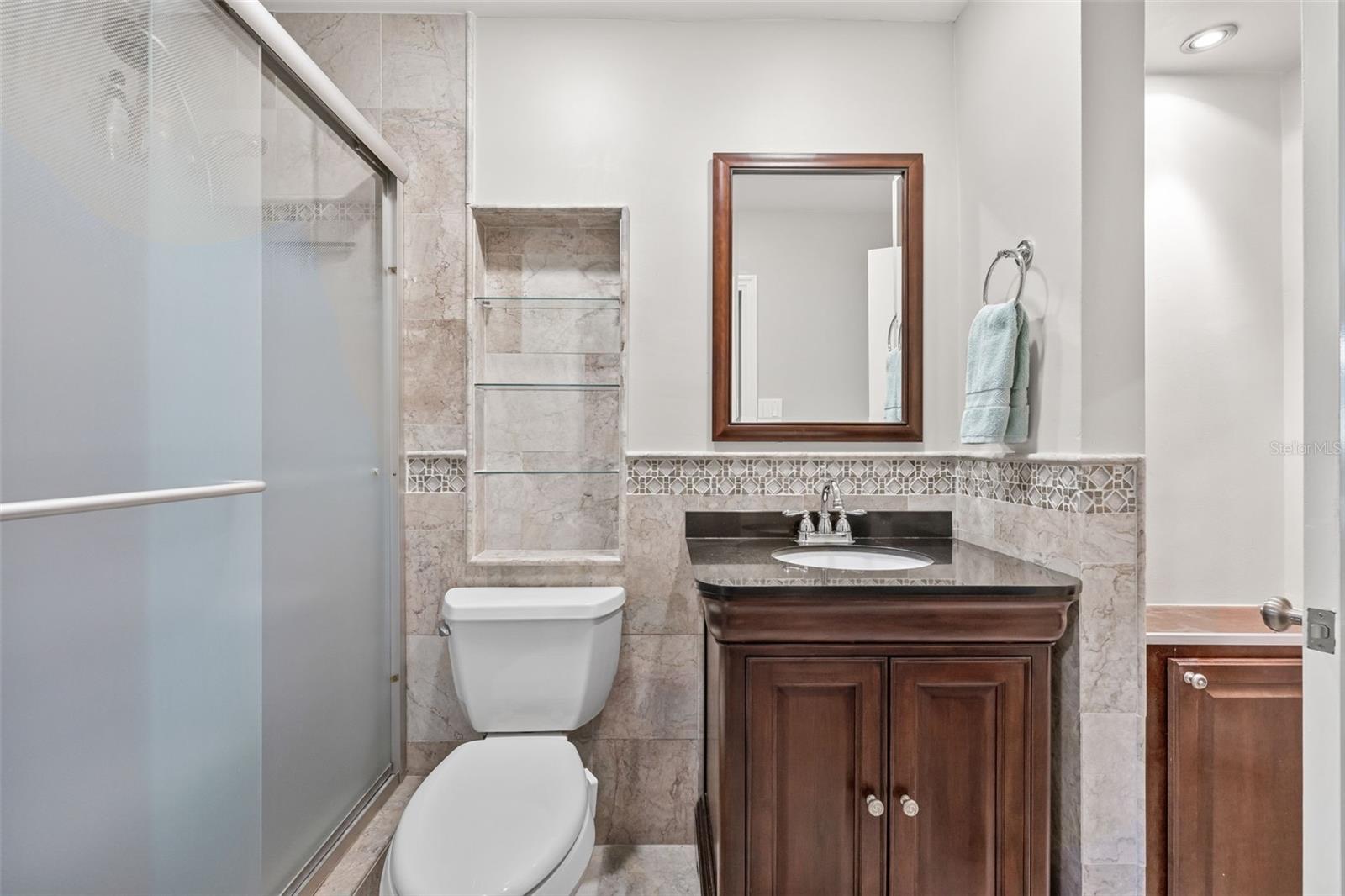 Bathroom with shower located off of the Primary bedroom and Florida room.