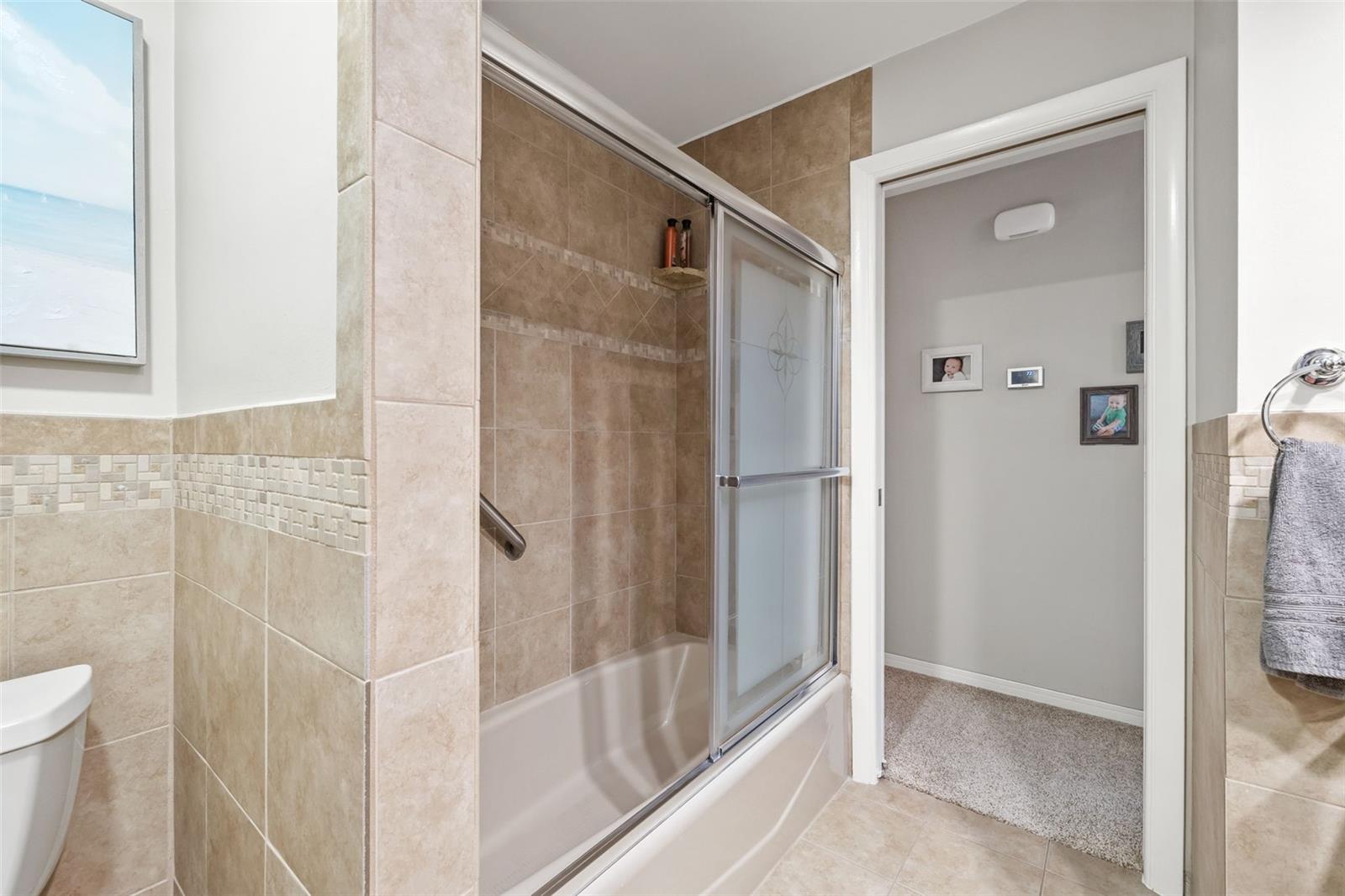 Hallway bathroom with tub.