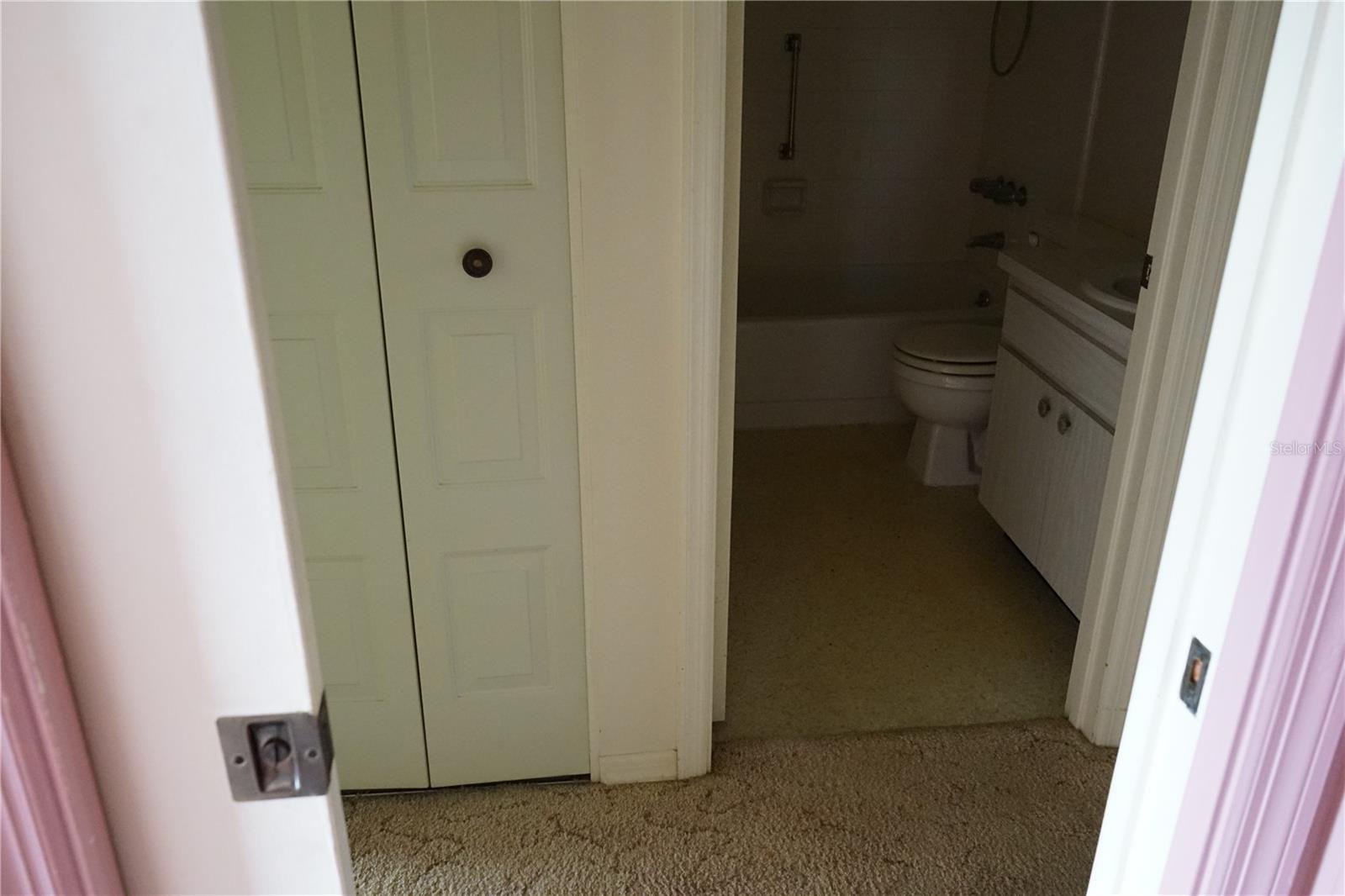 primary bedroom has pocket door for privacy and there is a linen closet in the hallway