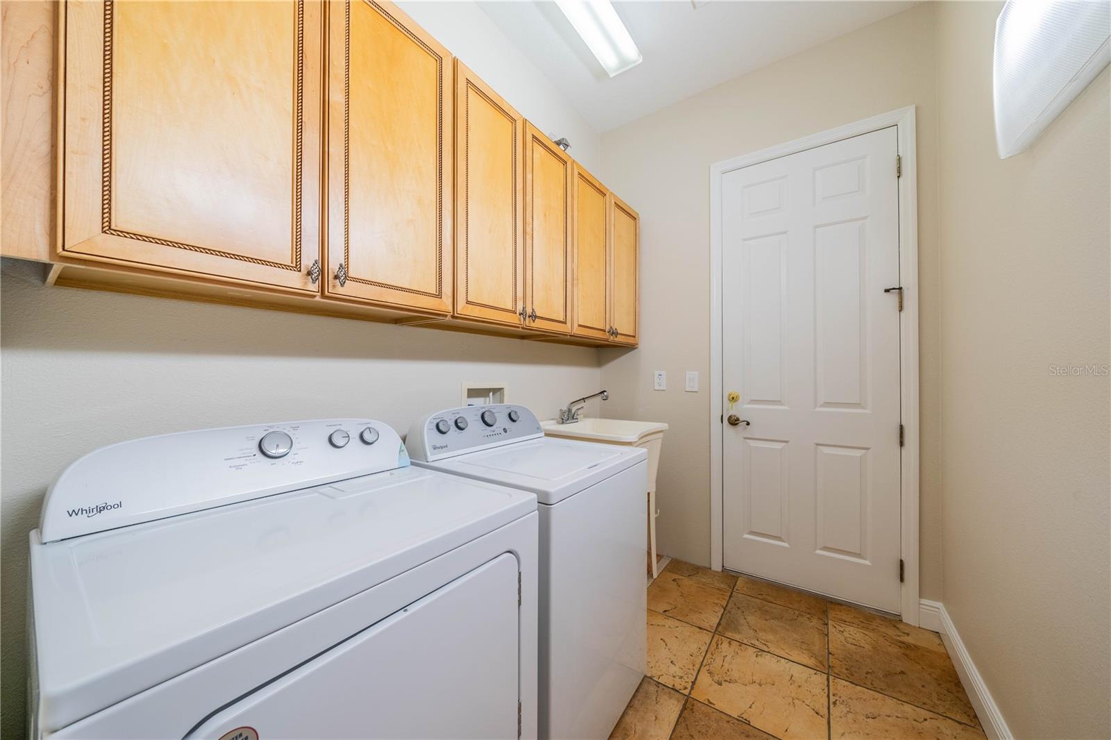 LAUNDRY ROOM WITH BUILT-IN CABINETS, LAUNDRY SINK AND TILE FLOORING