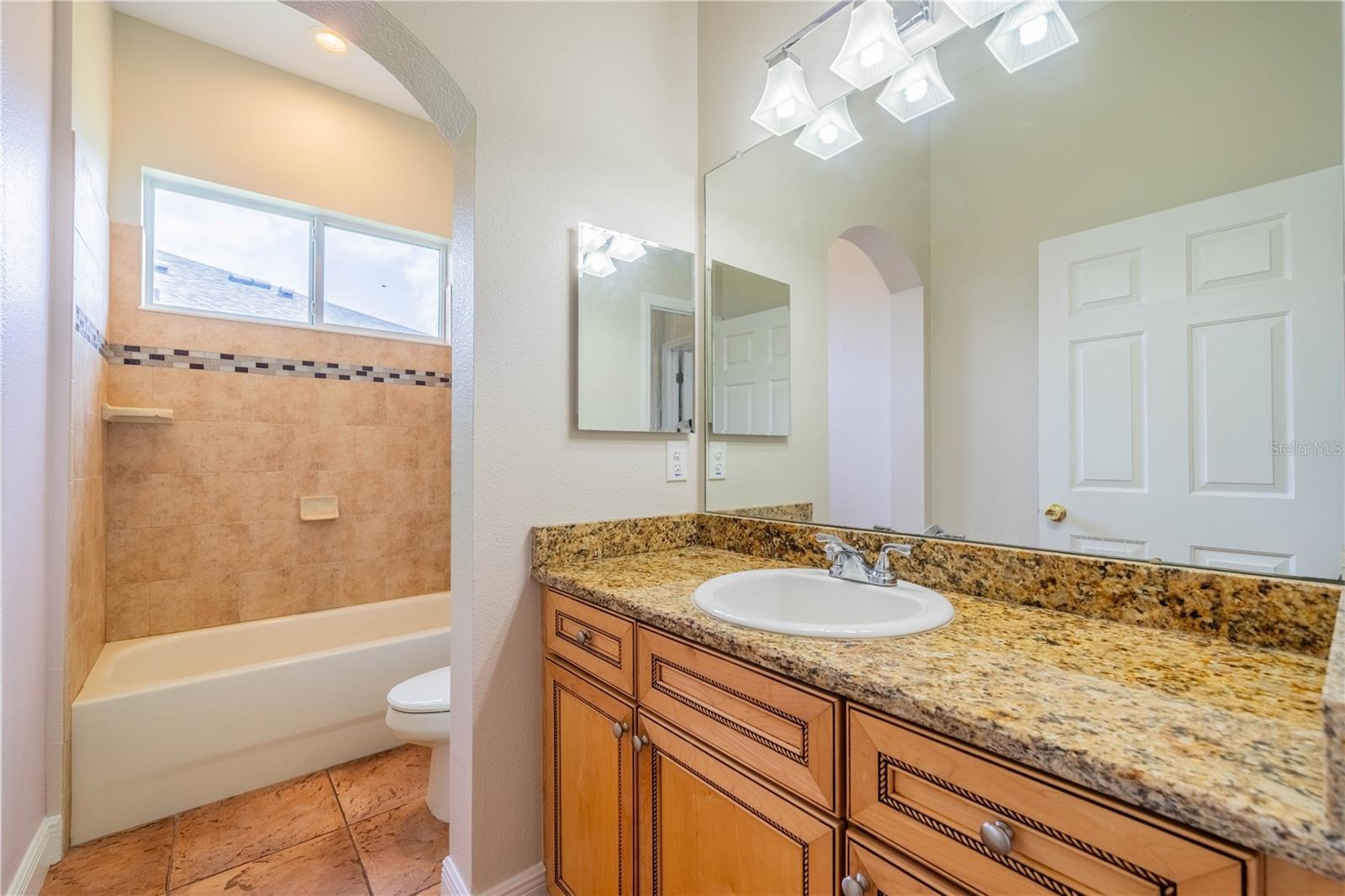 GUEST BATH WITH UPGRADED VANITY AND GRANITE TOP