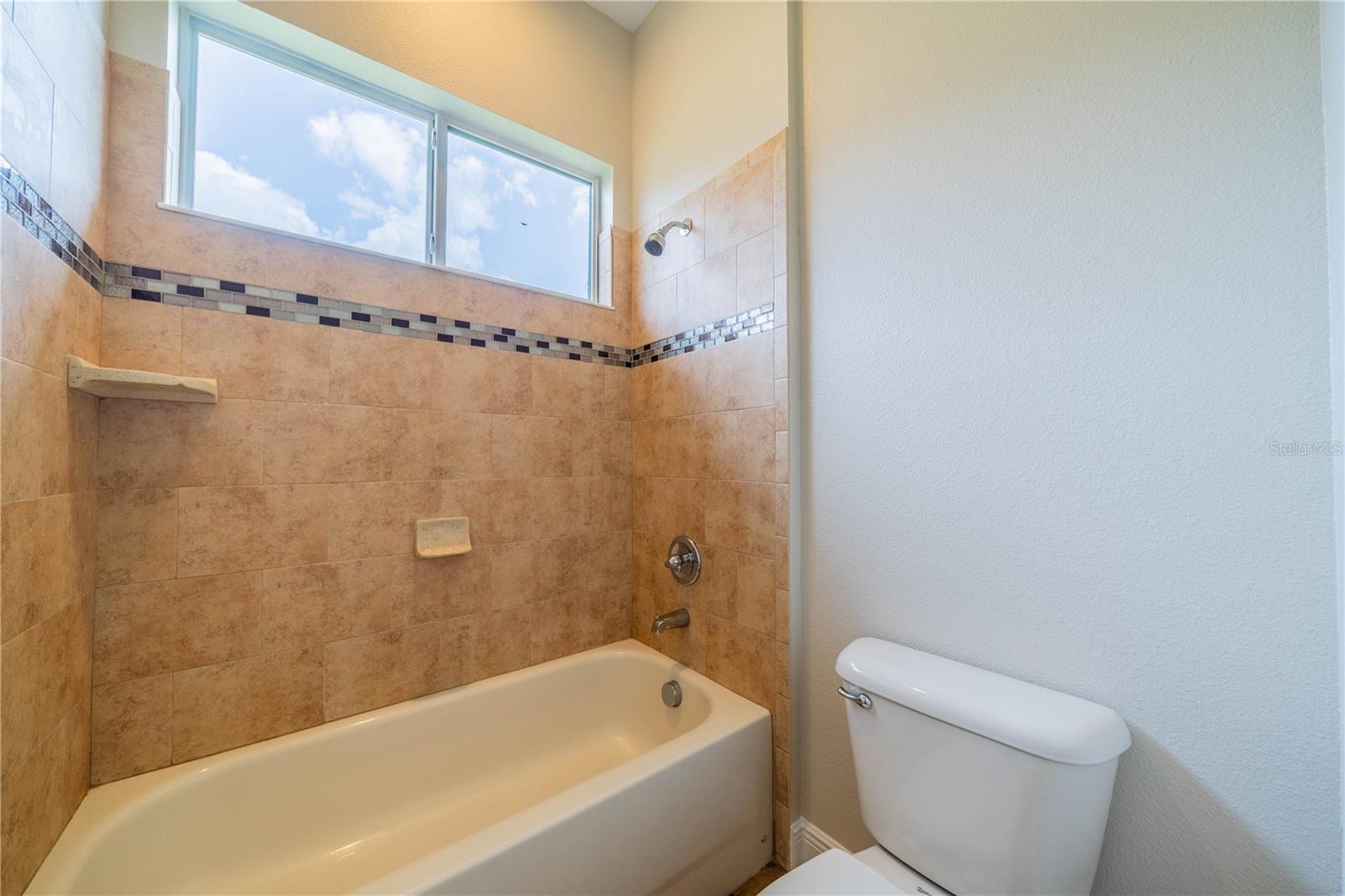 GUEST BATH HAS FULL TUB AND SHOWER AND TILE INLAY