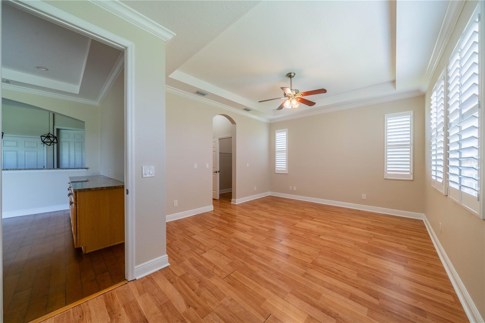 ENTER PRIMARY BEDROOM WITH CROWN MOLDING AND CEILING FAN