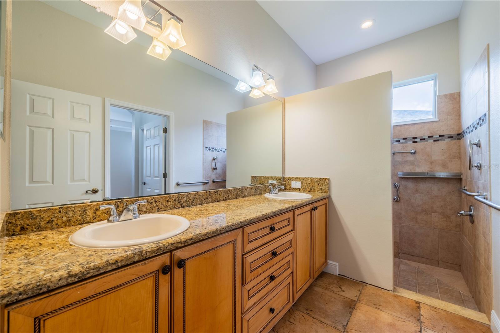 PRIMARY BATH WITH TILE FLOORING AND LARGE WALK IN SHOWER