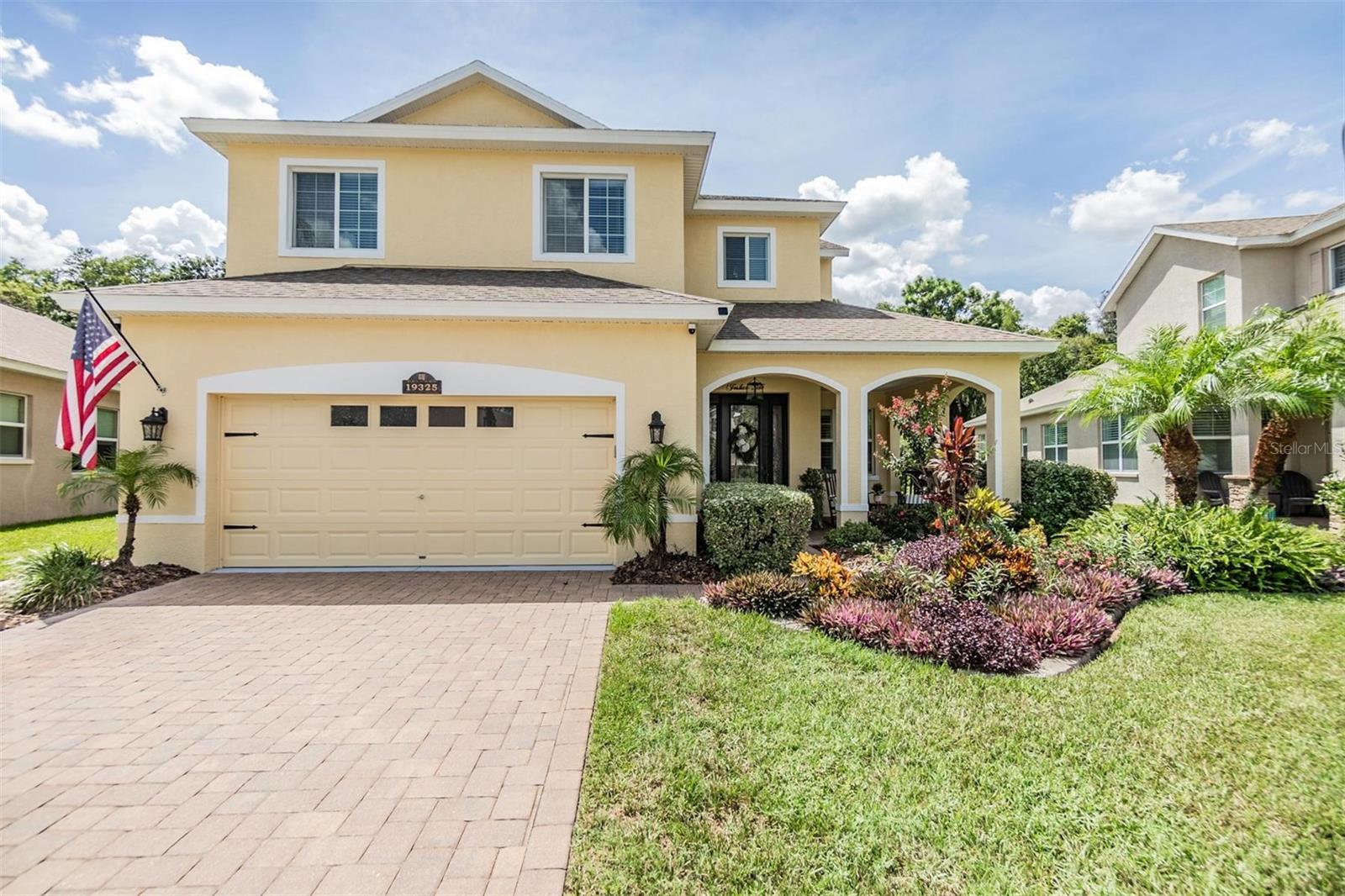 Paver driveway leads you into the spacious front porch