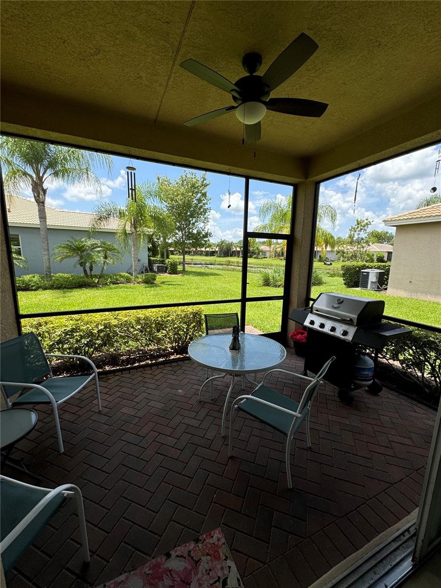 LANDSCAPE FROM YOUR SCREENED & COVERED LANAI OFFERS POND VIEW & GREEN SPACE.