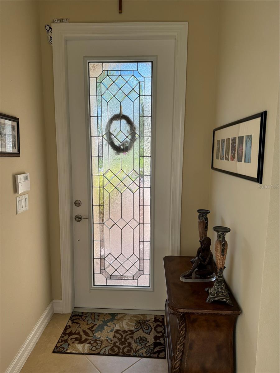 WELCOMING BEVELED GLASS FRONT DOOR ADDS NATURAL LIGHT