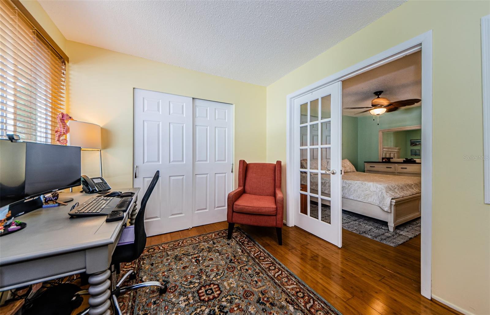 Flex space with French doors to primary bedroom